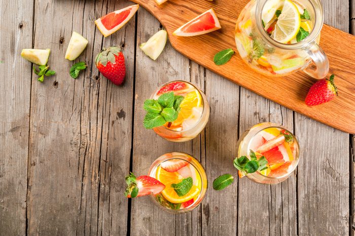 Pitcher and glasses of white sangria with slices of fruit