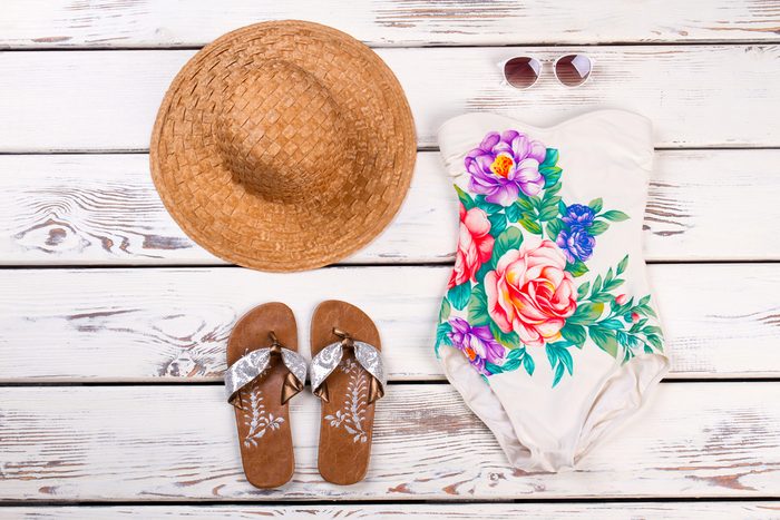 Swimsuit, sunhat, sunglasses, and sandals