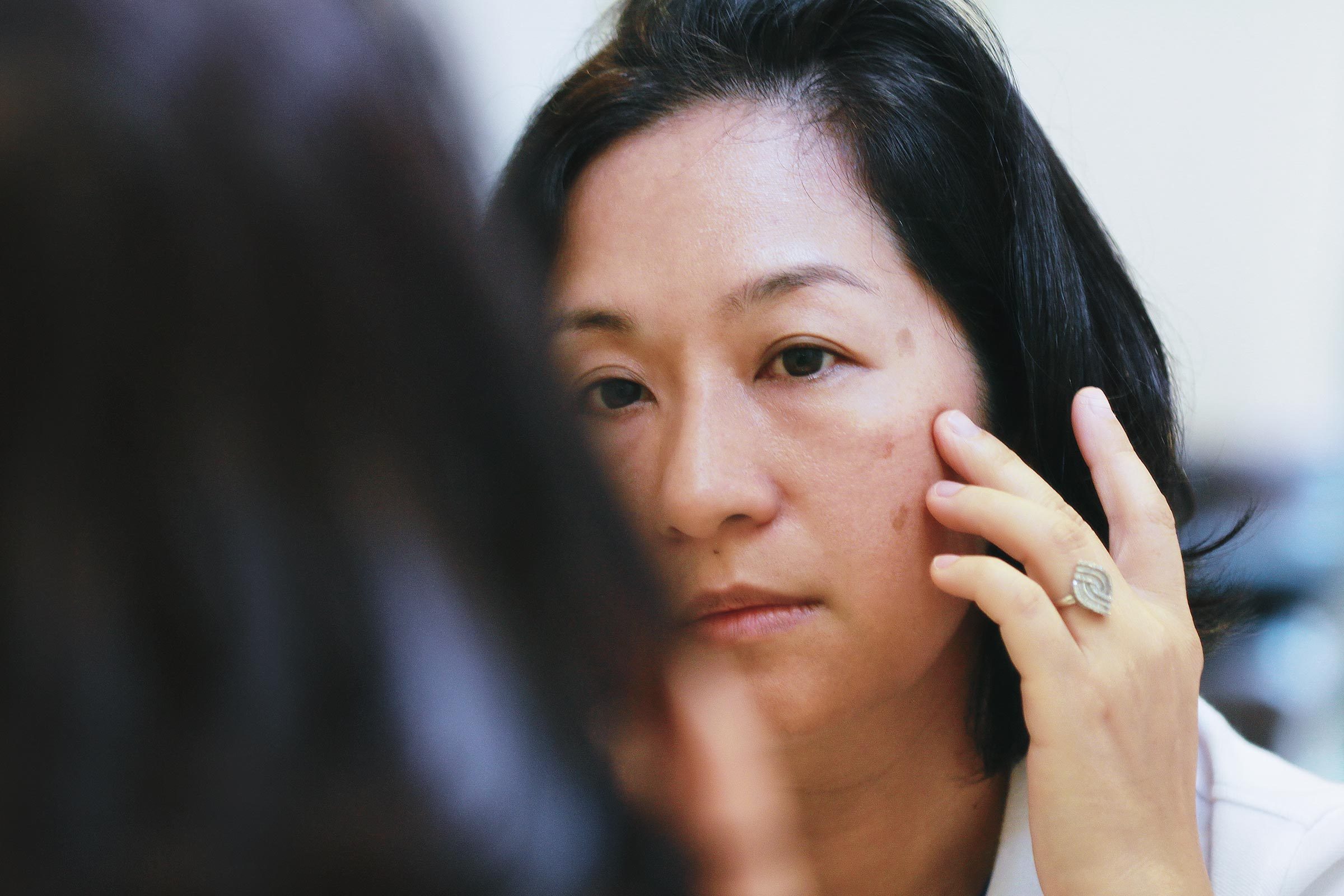 woman looking at face skin