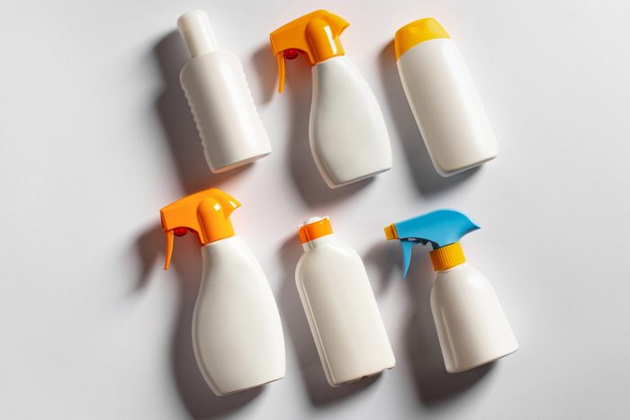 various sunscreen bottles on gray background