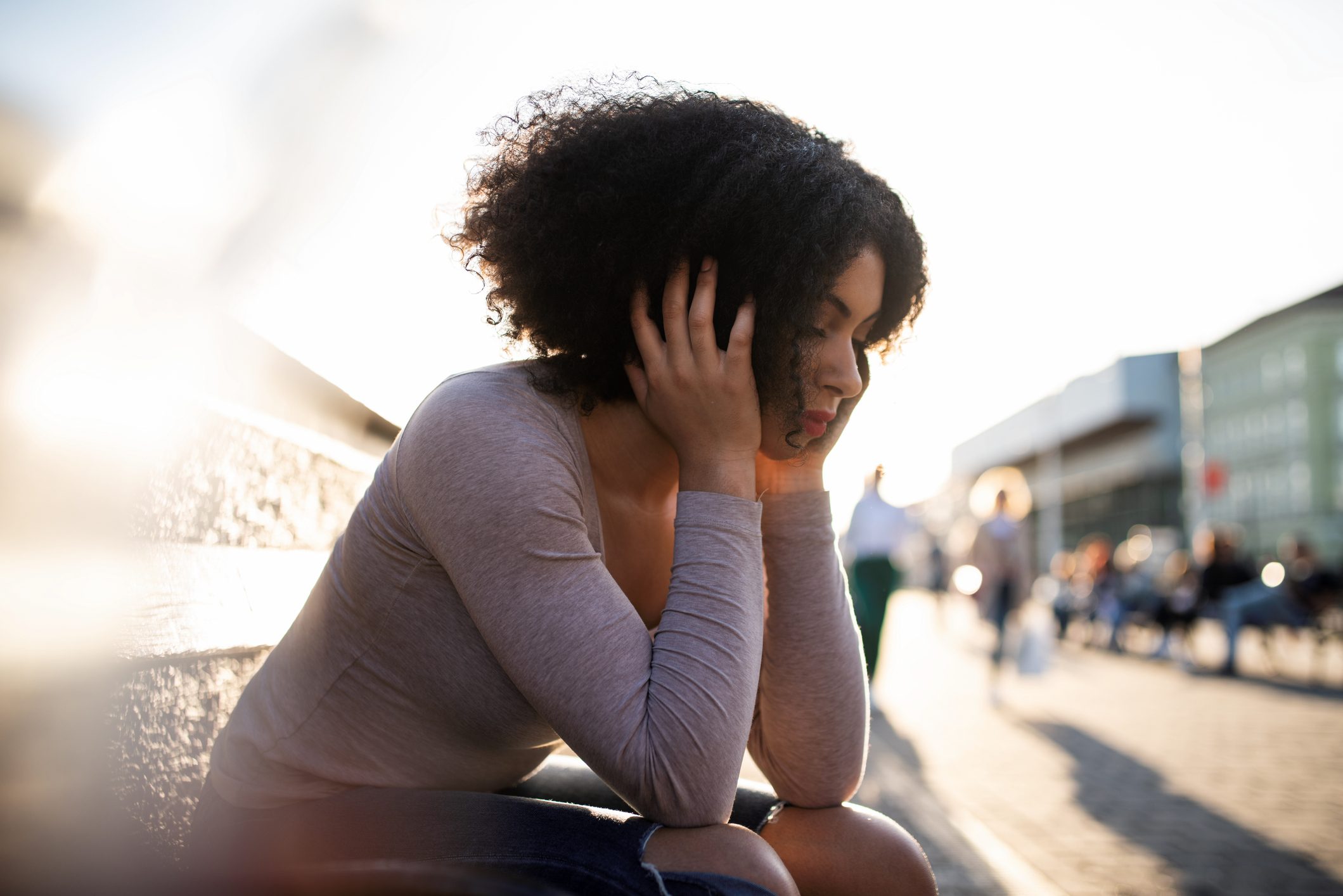 unhappy woman sitting on bench