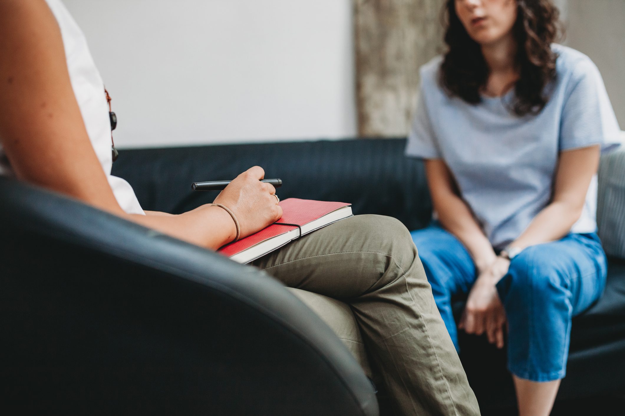 woman in therapy talking to psychologist or psychiatrist