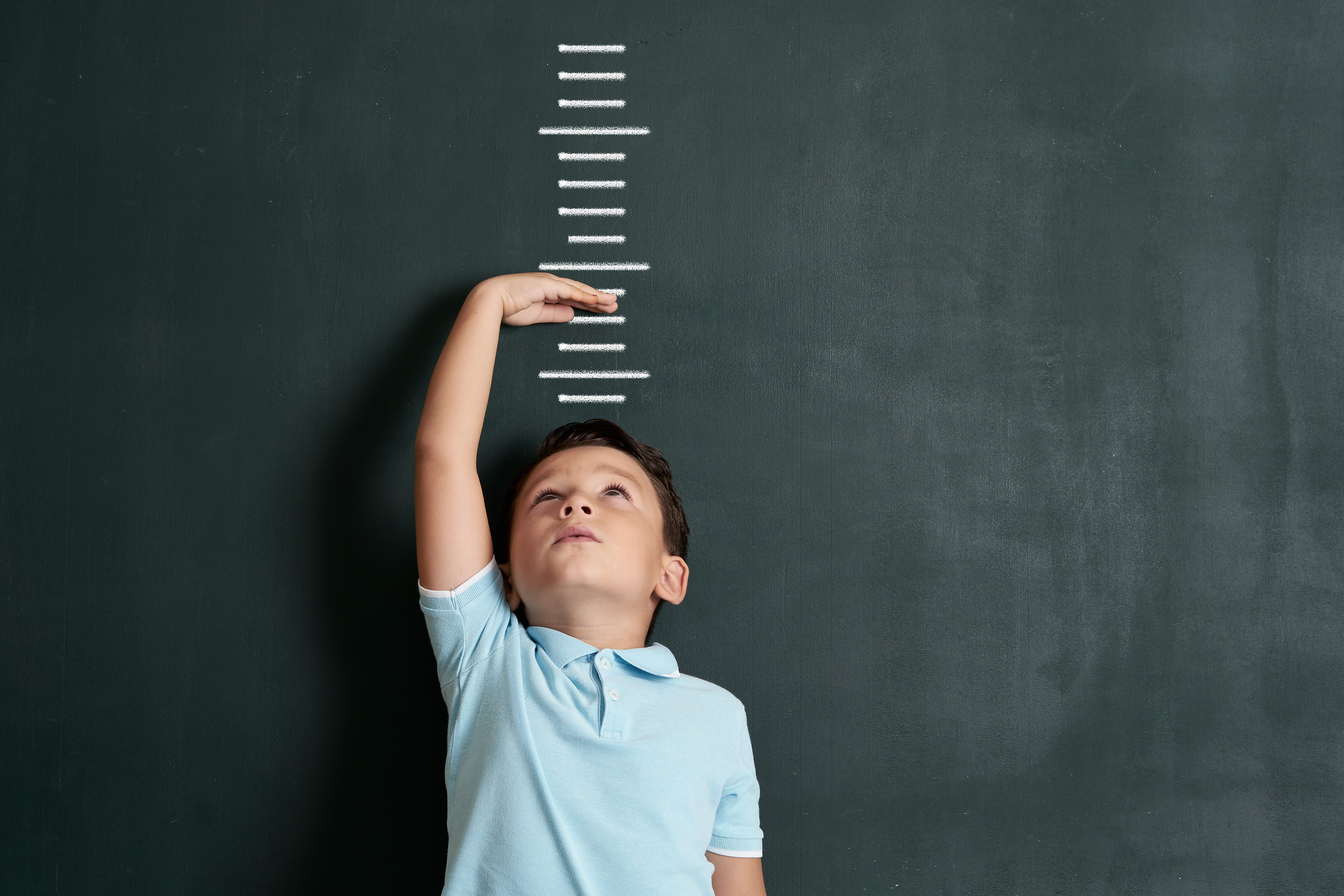 boy going size kid measure Child measuring his height on wall.