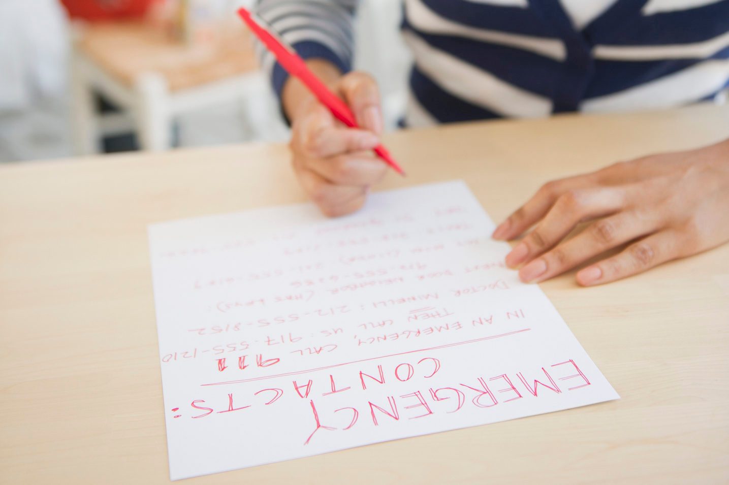 woman writing down emergency contacts