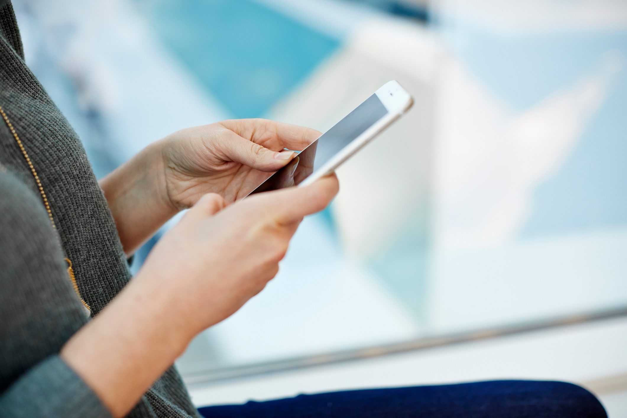 close up shot of woman holding smartphone