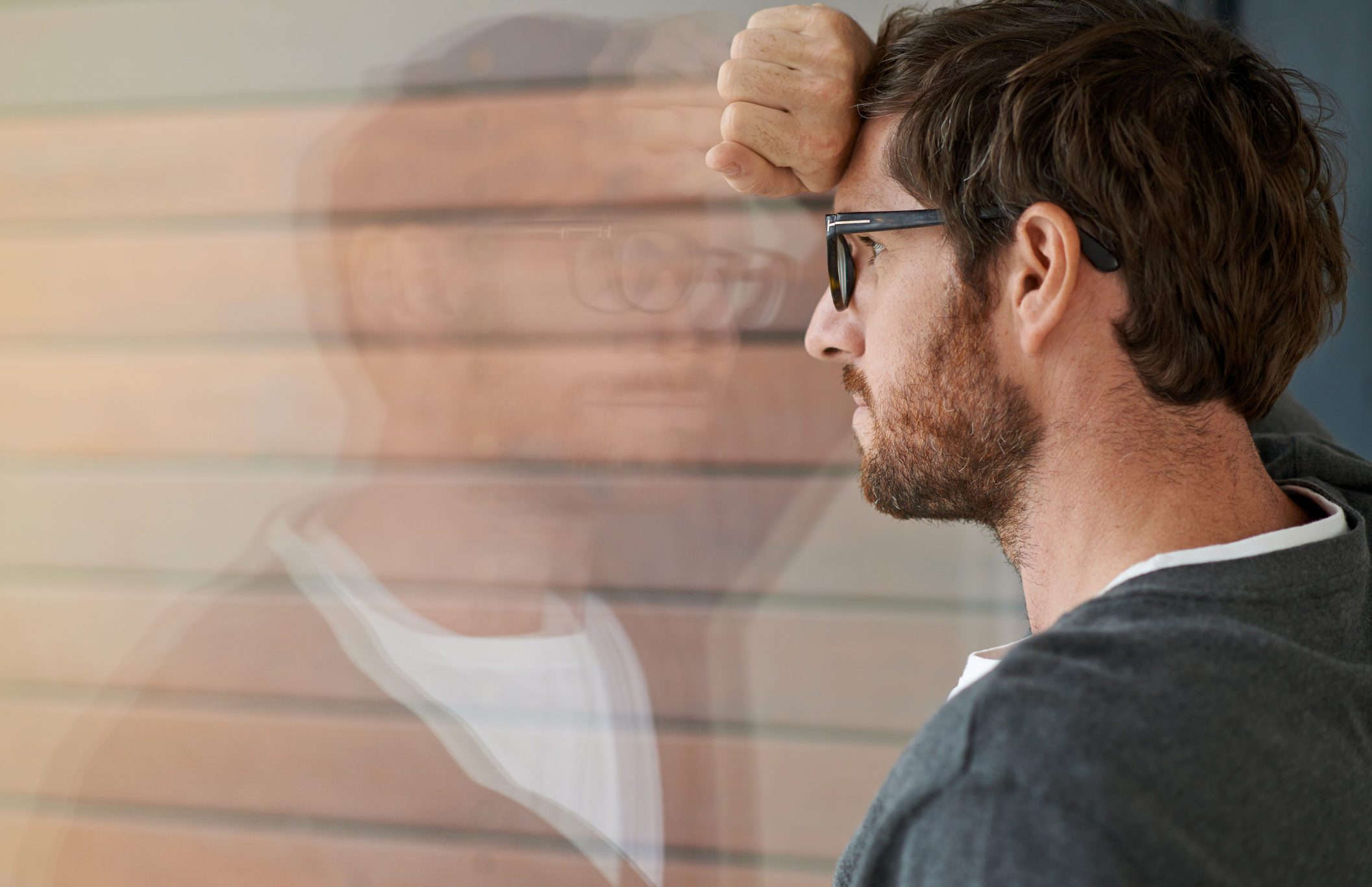 fears and anxiety man looking out window