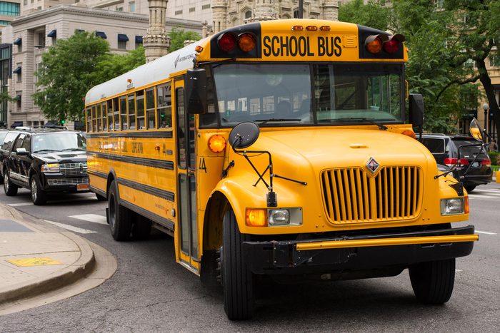 Bright yellow school bus on a city road