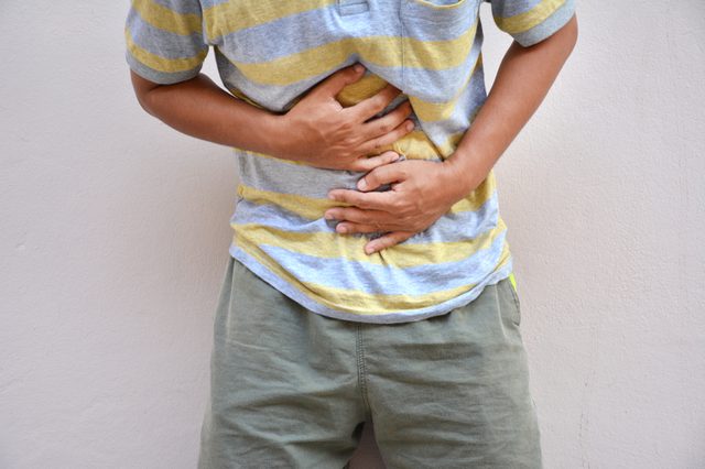 man having painful stomachache.Chronic gastritis. Abdomen bloating concept.