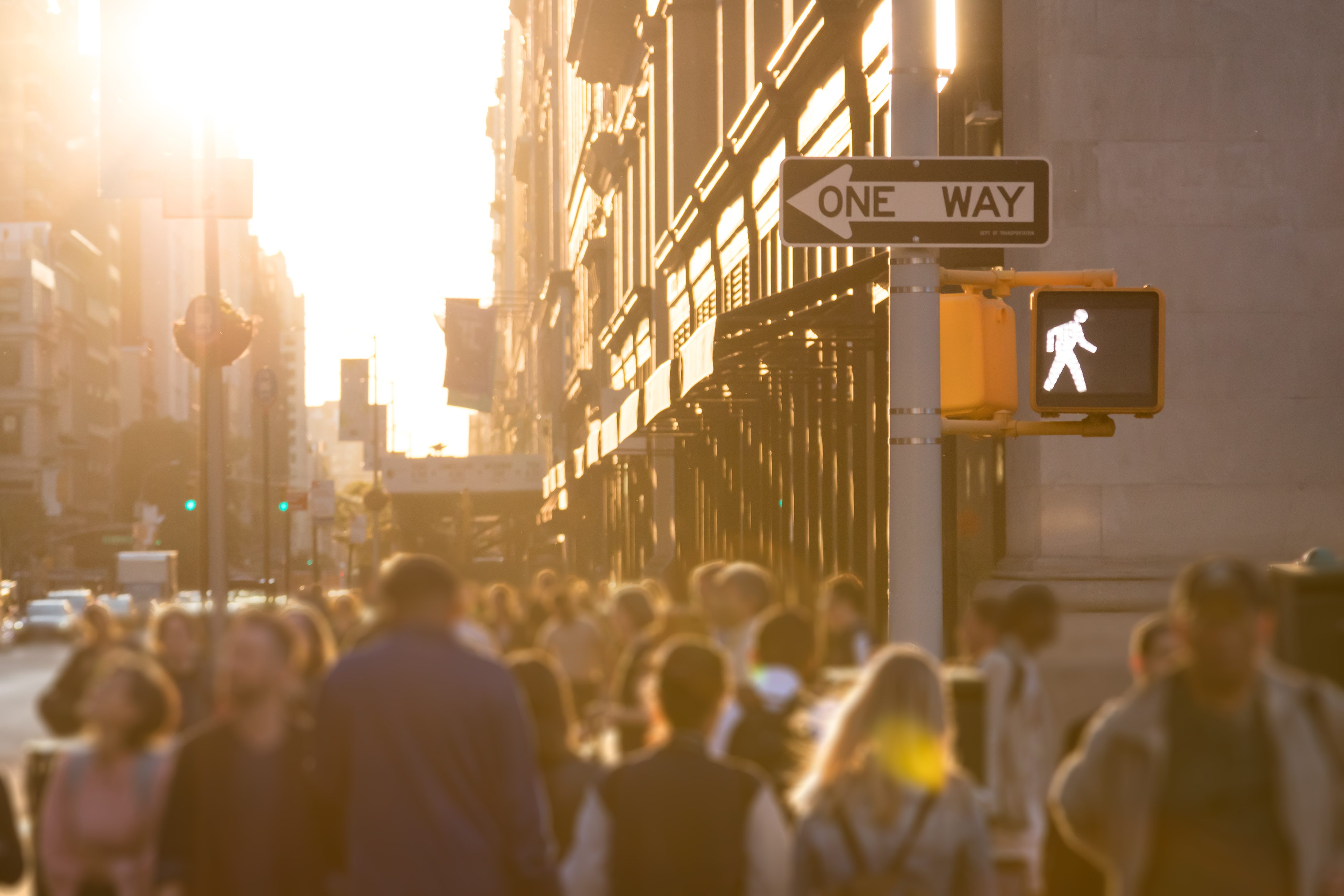 blurred pedestrians walking in city