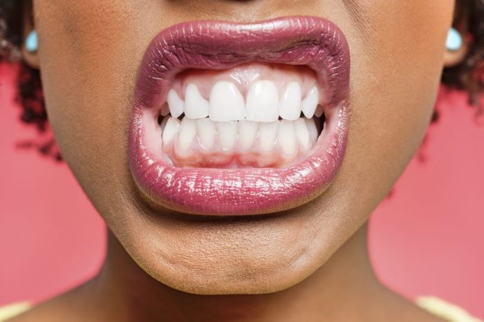 Cropped image of woman clenching teeth