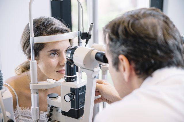 Eye Doctor examinating a young patient