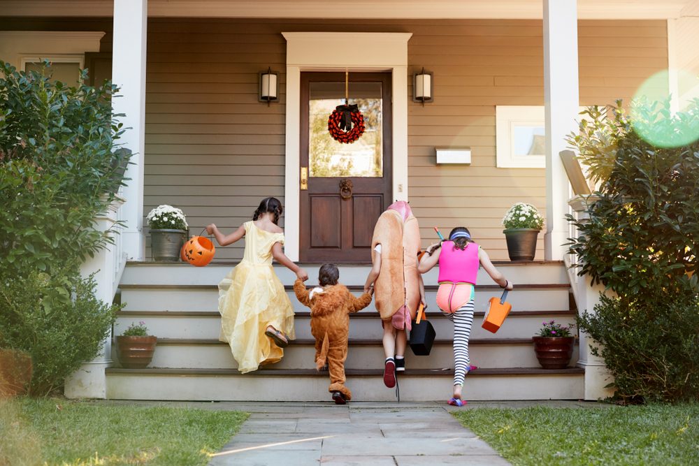 Children Wearing Halloween Costumes For Trick Or Treating