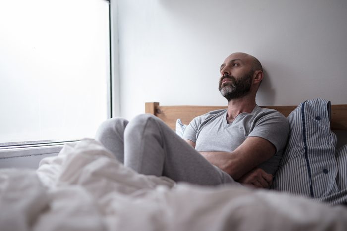 sad or sick man in bed