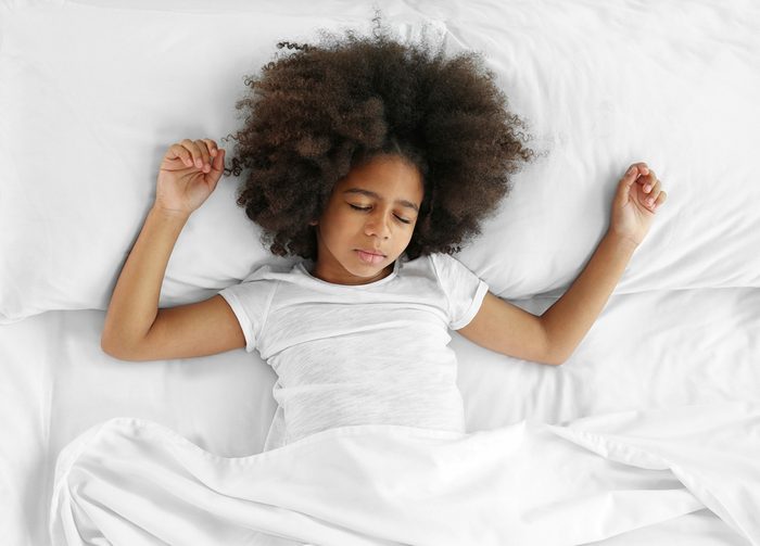 child sleeping in bed
