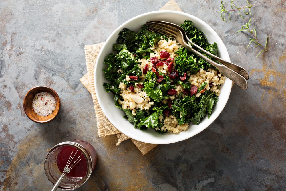 Healthy raw kale and quinoa salad with cranberry and almonds