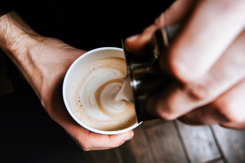 Barista making coffee latte art