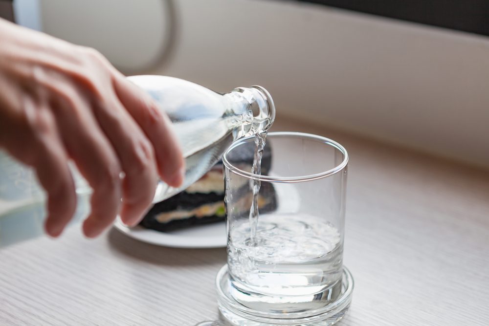 pouring water into glass