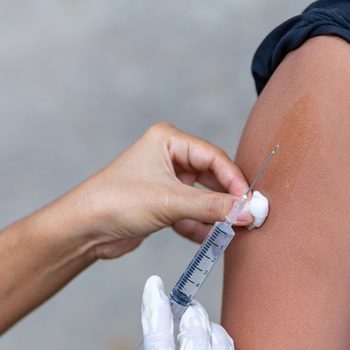 Doctor give injection to boy's arm , healthy and medical concept