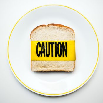 bread on plate with caution tape shot from above