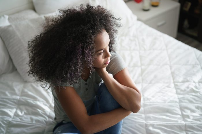 Young woman gazing out window