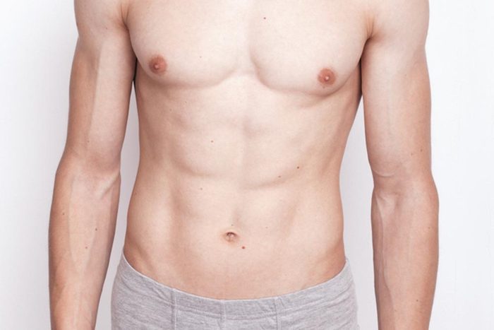 young man with an athletic figure and embossed muscles posing in underwear.