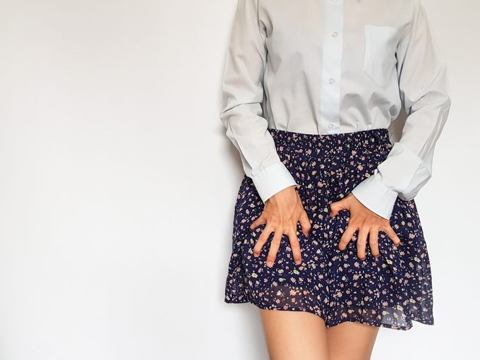 woman with hands on skirt