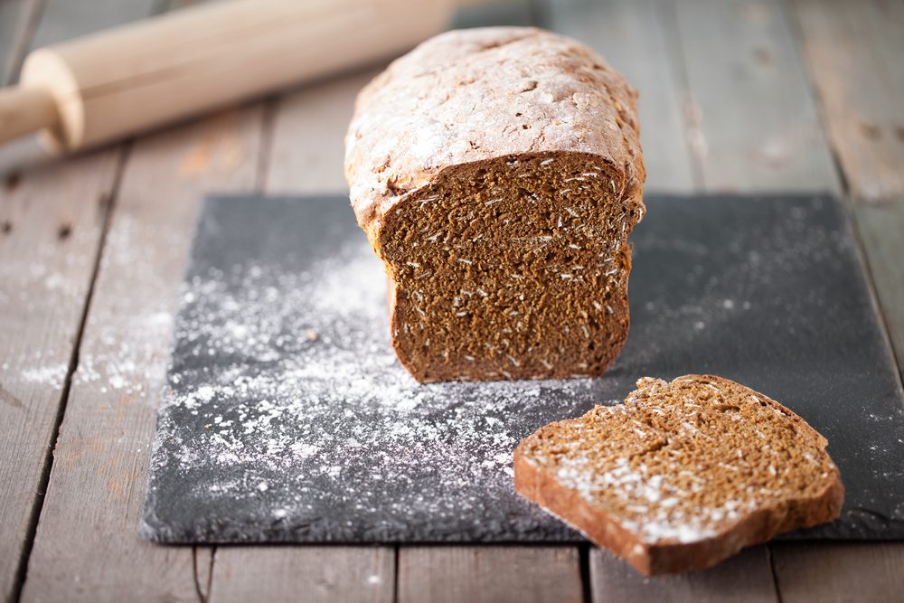 Fresh Irish soda bread with oat sliced on a slate cutting board Wooden background Copy space Selective focus