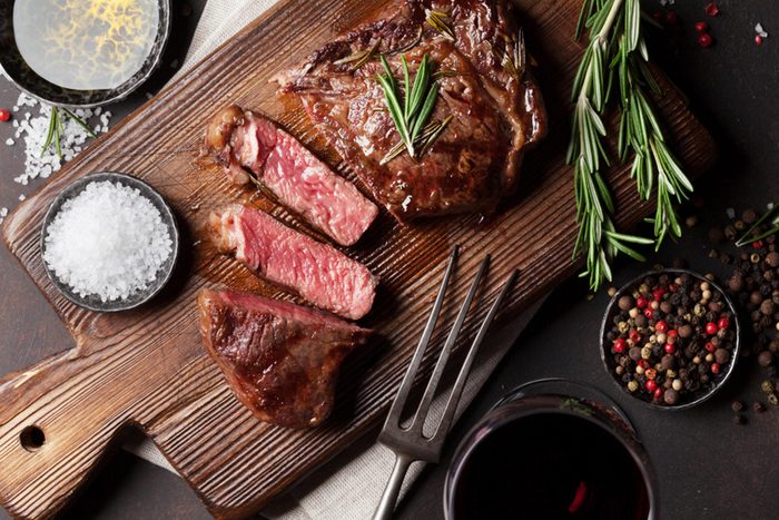 wooden board with red meat