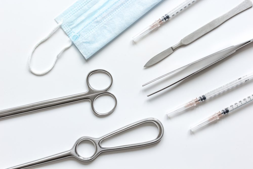 instruments for plastic surgery on white background