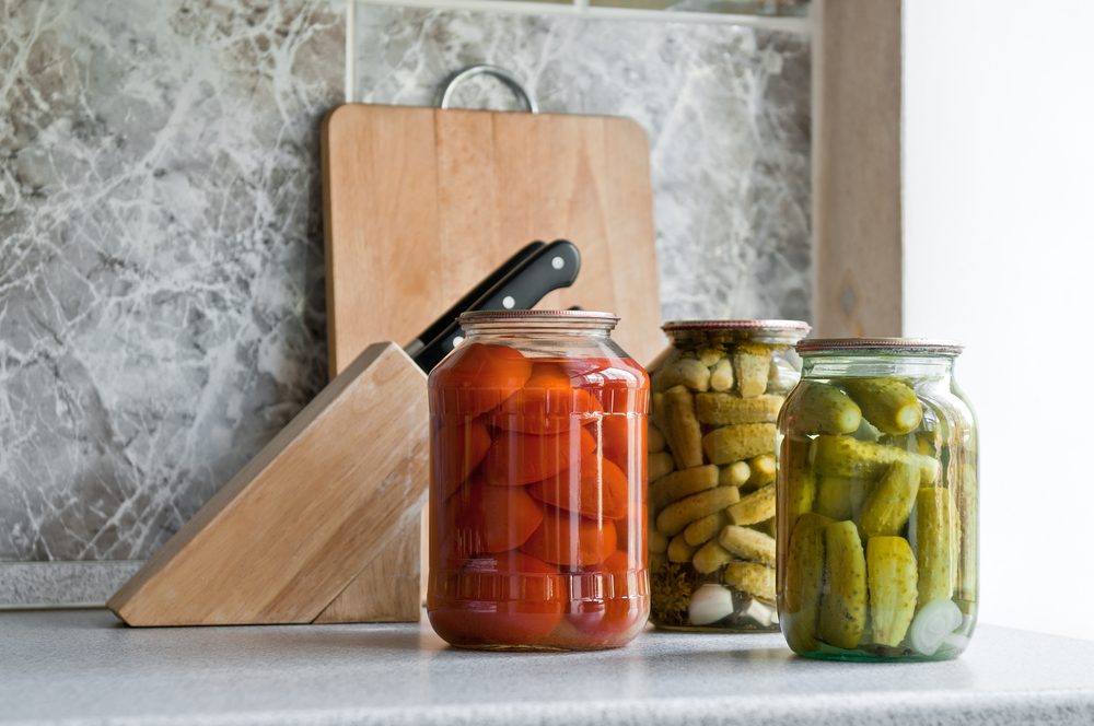 pickled cucumber and tomato in glass on the kitchen table