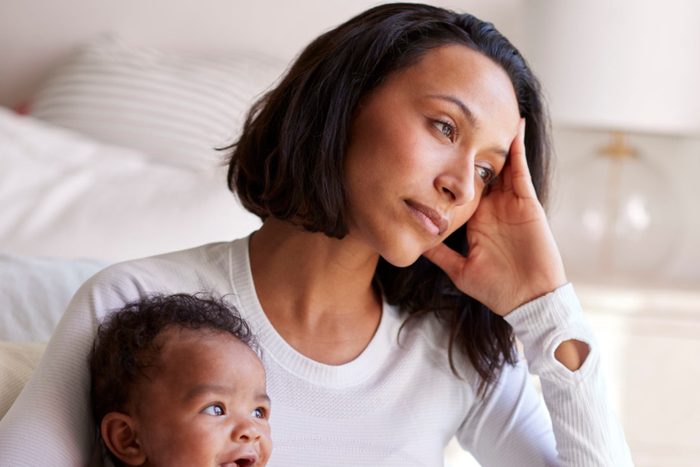 mother holding baby at home