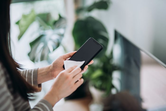 woman cleaning cell phone