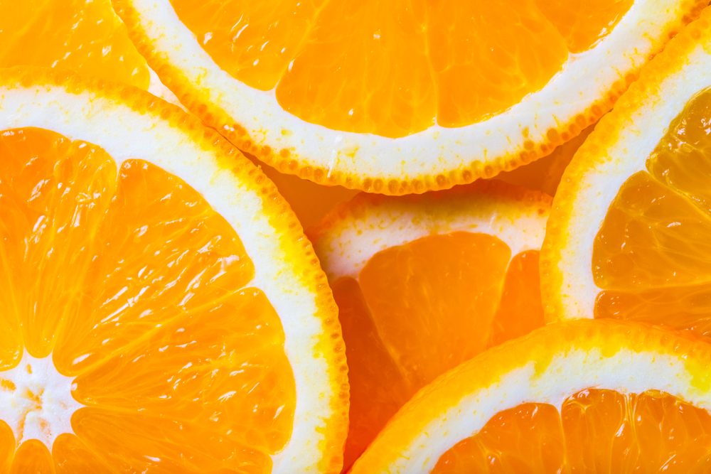 background made with a heap of sliced oranges