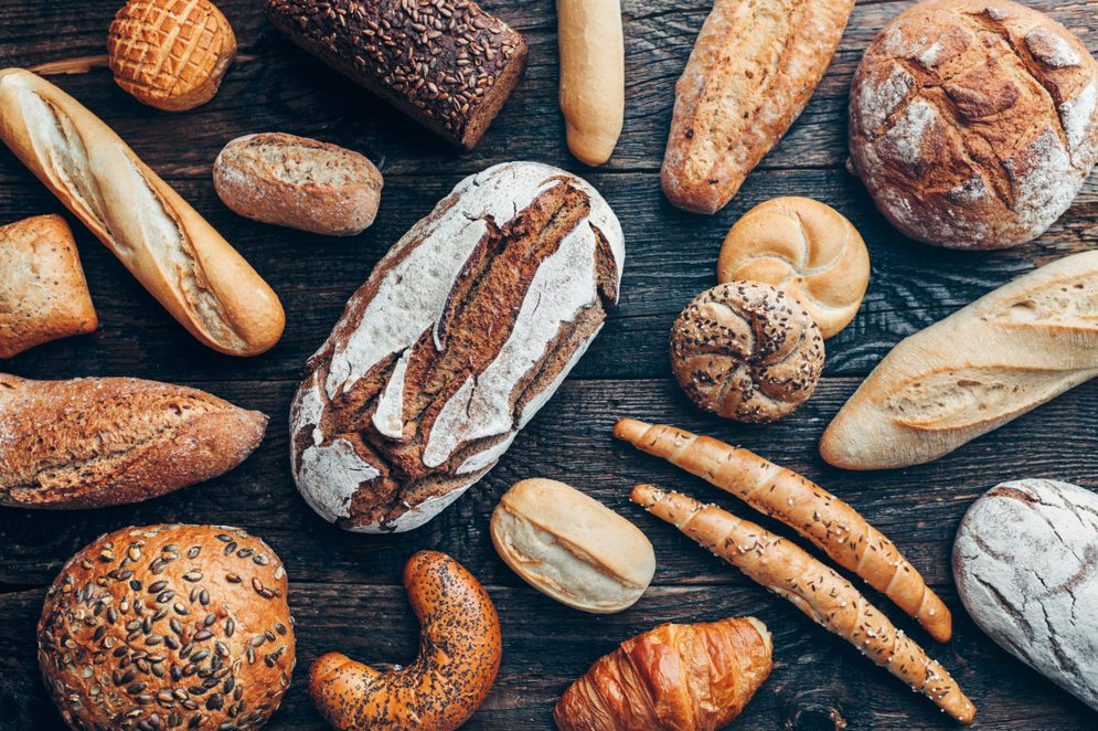 Delicious freshly baked bread on wooden background