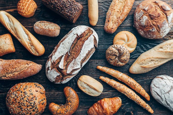 Delicious freshly baked bread on wooden background
