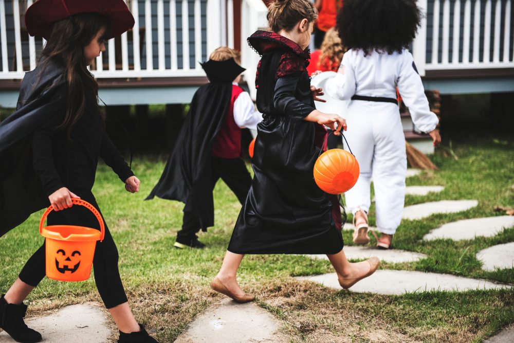 Young kids trick or treating during Halloween