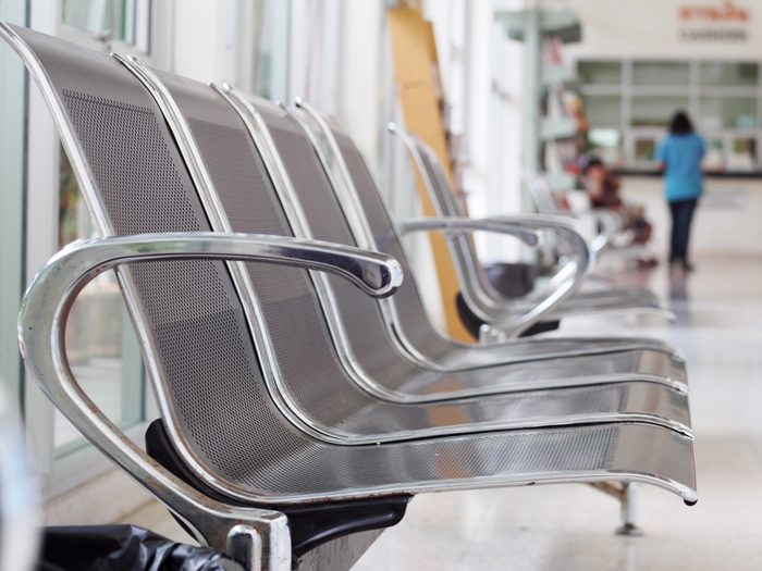 close up shallow depth of field photo of stainless steel chair installed on a balcony terrace public area for customer of a vet animal hospital as functional orientated interior furniture design