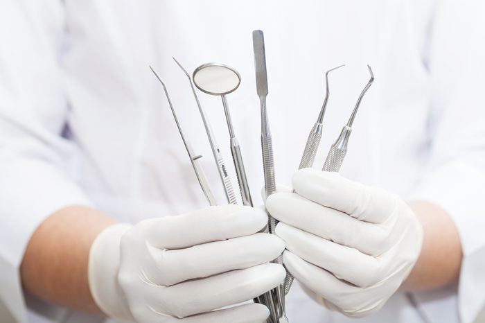 dentist holding dental tools