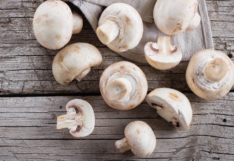 Fresh mushrooms champignons on a wooden background. Autumn Harvest Food Vegetarian Vegetable. Top View, Copy Space