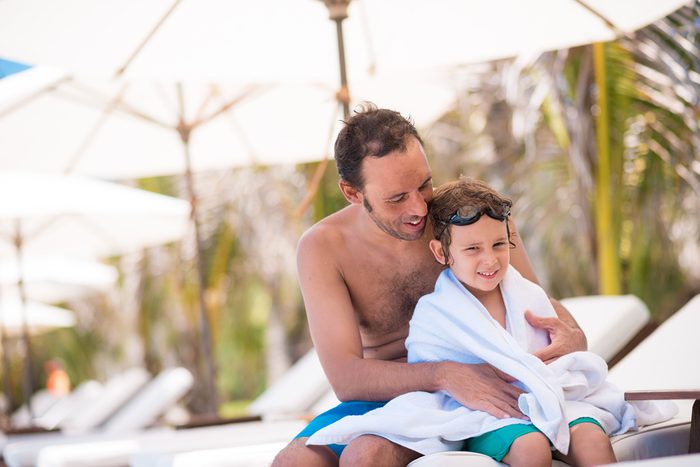Portrait of man and his son after swimming in the pool