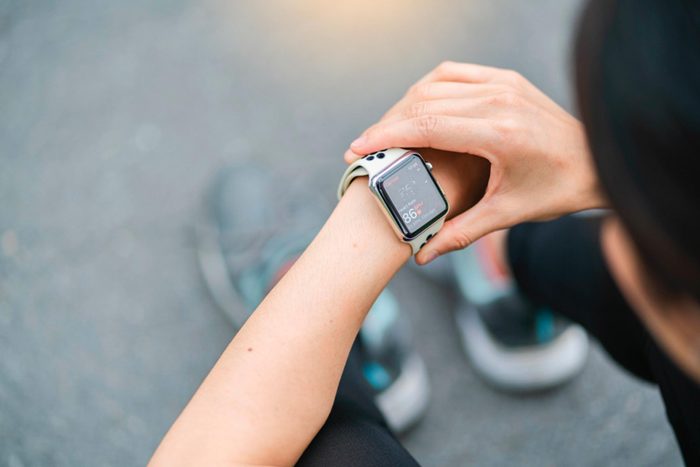 Person checking step counter on fitness tracker