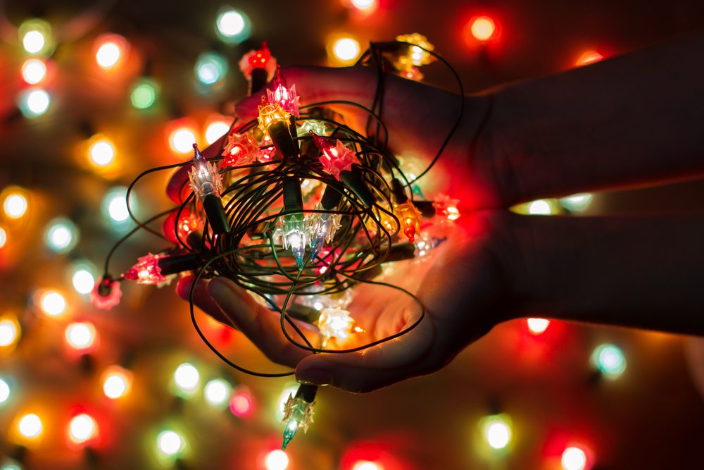 Christmas light bulbs in hands