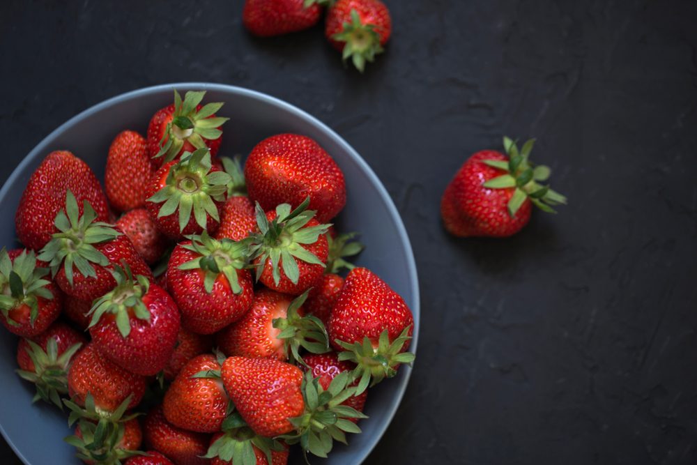 Fresh strawberries in a bowl. bowl with strawberries, freshly picked strawberries concept. Heap of fresh strawberries in ceramic bowl 