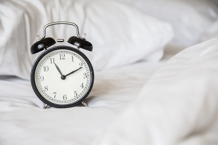 Retro alarm clock on the bed