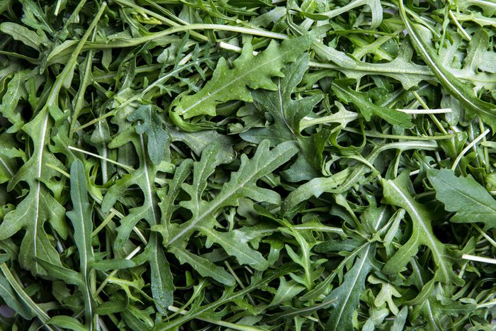 fresh arugula on white background