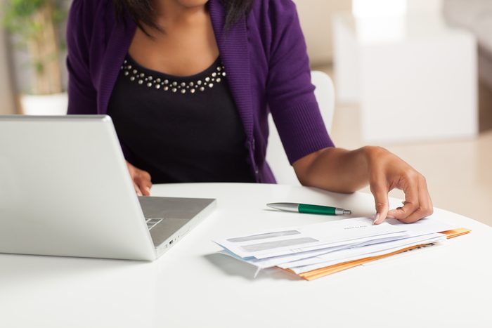 woman paying bills at laptop