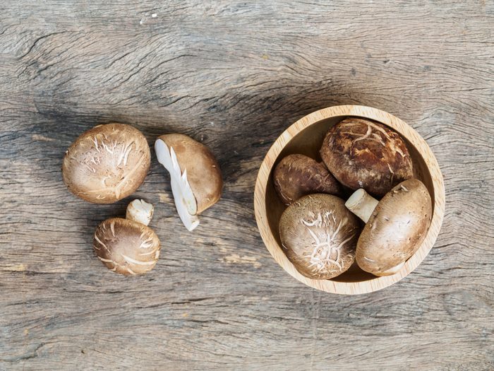 Top view of fresh mushroom (shiitake) on rustic background
