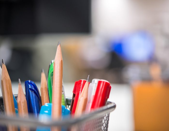 Pencils and pens in a box