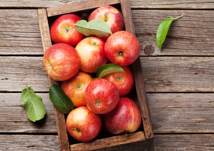 Ripe red apples in wooden box. Top view with space for your text