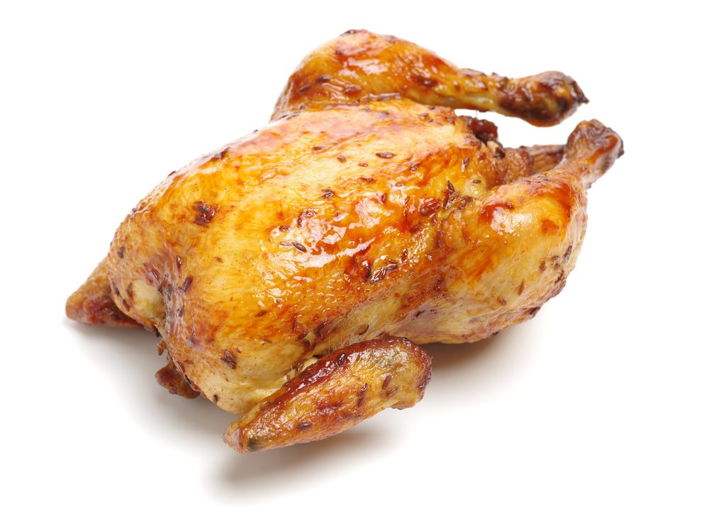 Whole roasted chicken against white background